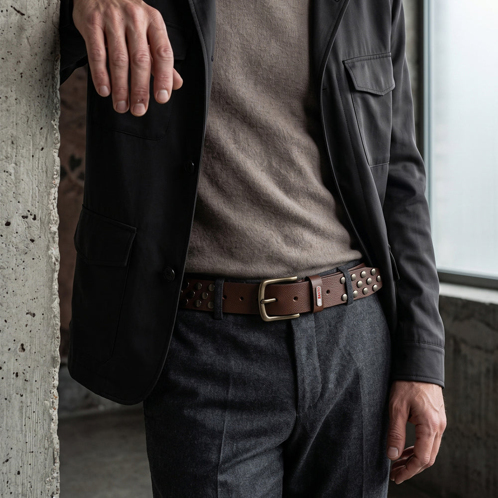 Berbanto Rustline espresso brown studded leather belt styled with tailored trousers and blazer.